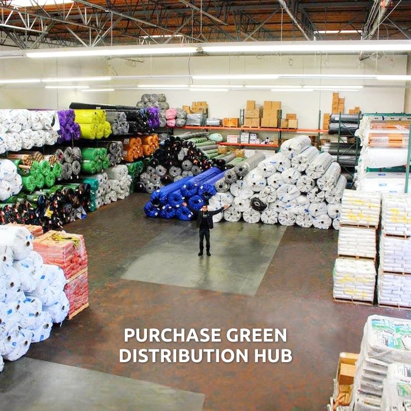 Image of man standing in large warehouse with arms outspread to indicate wide variety of stocked products; text in foreground: Purchase Green Distribution Hub