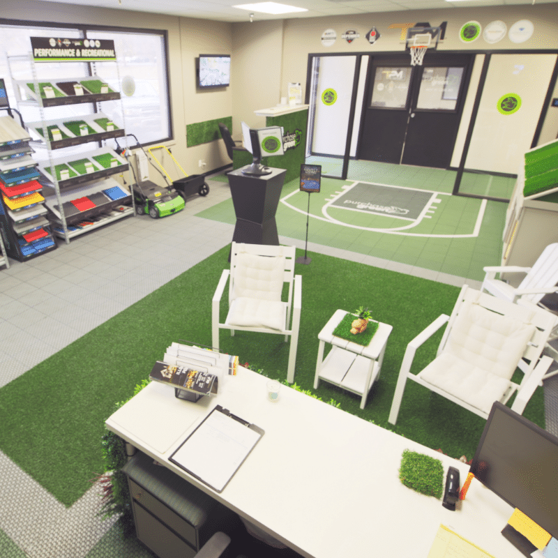 Purchase Green West St. Louis office seen from above the sales desk, showing a tidy room of neatly arranged artifical turf and game court tile displays