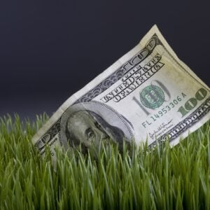 installer using a stake to secure turf